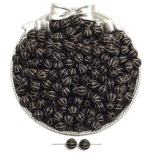 Macro detail of acrylic black melon beads with gold stripes for DIY jewelry making