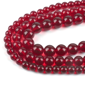 Macro view of deep red transparent glass round beads with smooth finish for DIY jewelry