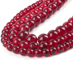 Macro detail of translucent pomegranate red glass beads for handmade jewelry design