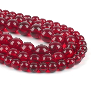 Macro shot of high-gloss translucent red glass round beads for DIY jewelry making