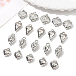 Silver CCB heart and bow pendants for DIY jewelry making, including various textured charms