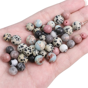 Macro detail of various natural dalmatian jasper and gemstone beads for DIY jewelry making
