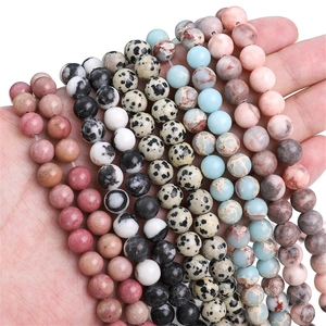 Natural round stone beads featuring Dalmatian jasper and rhodonite for jewelry making
