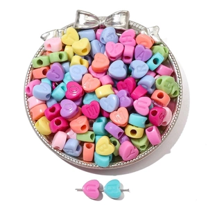 Macro detail of mixed color acrylic heart letter beads for DIY jewelry bracelet making