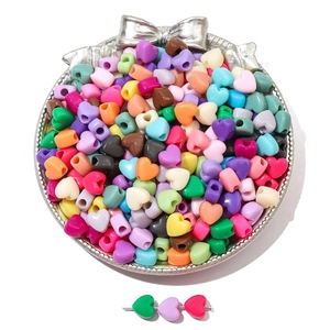 Colorful heart-shaped acrylic beads for DIY bracelets in a decorative silver tray