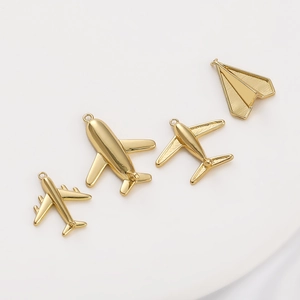 Macro shot of 14K gold-plated brass airplane pendants for DIY necklace jewelry making