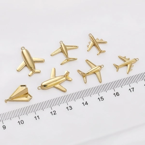14K gold filled airplane charms for DIY jewelry making with ruler for size reference