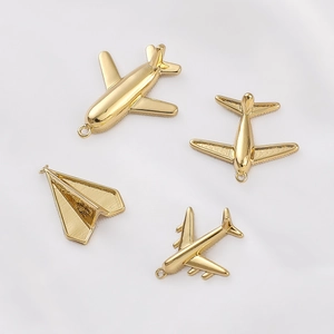 Golden airplane charms and paper plane pendants for DIY jewelry making and necklace crafts