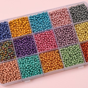 Vue détaillée de perles de rocaille colorées de 2-3 mm rangées dans une boîte à cases