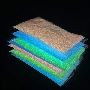 Glow-in-the-dark luminous sand granules in assorted neon colors for DIY crafts