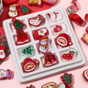 Macro shot of colorful acrylic Christmas charms like Santa and trees for DIY jewelry