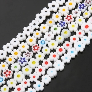 Macro shot of colorful glass plum blossom beads and star spacers for DIY jewelry making