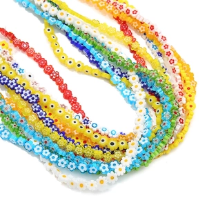 Macro detail of colorful flower-shaped glass beads for handmade jewelry DIY projects