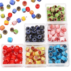 Handmade millefiori glass beads set with colorful stripe patterns in storage box