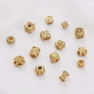 Golden brass spacer beads set with intricate flower designs and Fu character for DIY jewelry