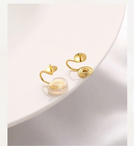 Detail of 14K gold plated spiral clip-on earring converters with soft silicone pads