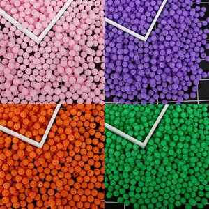 Macro shot of textured DIY ABS craft beads in pink, purple, orange, and green colors