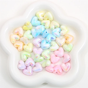 Macro view of colorful acrylic heart beads with AB iridescent finish for DIY jewelry