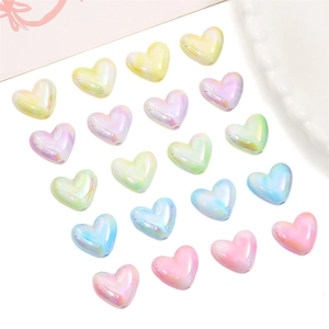 Macro shot of colorful acrylic heart beads with rainbow AB finish for DIY jewelry crafts