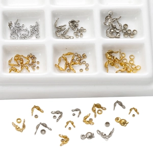 Detail view of gold and silver stainless steel crimp beads and covers for DIY jewelry
