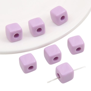 Macro view of purple acrylic cube beads with threading holes for DIY jewelry making