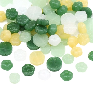 Detailed close-up of mixed jade-style beads with floral and fortune character carvings