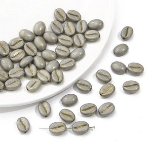Macro-opname van acryl koffieboon kralen in grijs en goud voor DIY sieraden maken