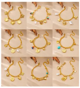 Detail showcasing nine gold-plated beaded bracelets with diverse charms on a soft fabric
