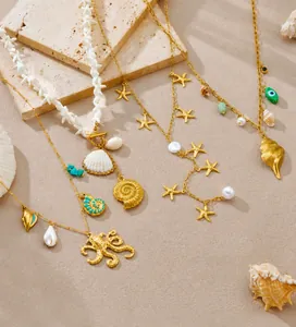 Detailed view of layered gold ocean necklaces with seashells and starfish charms