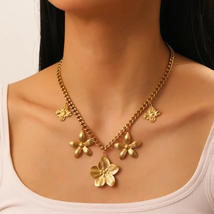 Vintage gold-plated stainless steel necklace with textured floral pendants on a Cuban chain