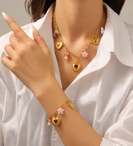 Detail of vintage gold-plated necklace with heart, mushroom, and floral charms on model