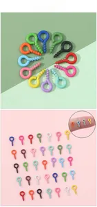 Macro shot of colorful tiny screw eye pins for DIY jewelry making with size reference