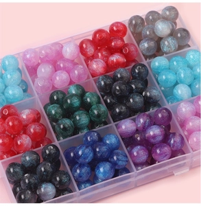 Close-up of starry gradient resin mermaid beads in a transparent plastic organizer box