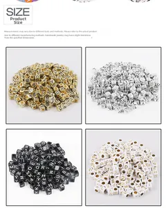 Macro detail of cube acrylic alphabet beads in gold, silver, black, and white for DIY jewelry