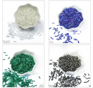 Macro view of 2x6mm glass bugle beads in white, royal blue, dark green, and gun black