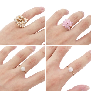Detailed grid view showing four handmade DIY rings with pearls and floral resin designs