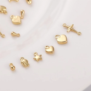 Macro detail of various 14K gold plated charms for DIY necklaces and jewelry making