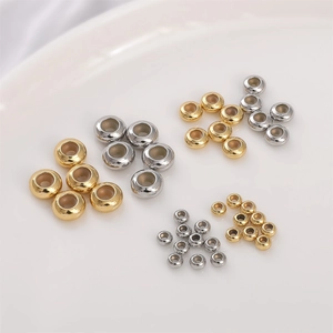 Macro shot of 14K gold filled and silver spacer beads in three sizes for DIY jewelry