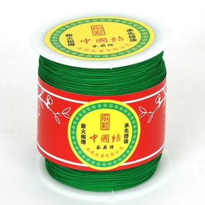 Durable green braided nylon cord on white spool for DIY Chinese knot jewelry making