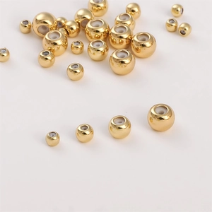 Macro view of 14K gold filled silicone slider beads in various sizes for DIY jewelry