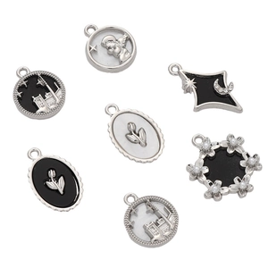 Macro view of assorted alloy pendants including angel and star patterns for DIY jewelry