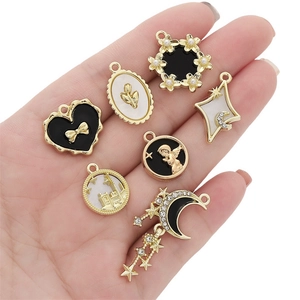 Golden alloy DIY charms set featuring heart, star, and moon designs with pearl accents
