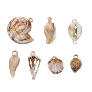 Macro view of shell-shaped acrylic DIY pendants with tortoiseshell pattern for jewelry