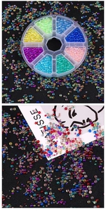 Macro shot of colorful iridescent glass bubble beads for DIY jewelry making in a plastic box