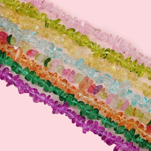 Colorful irregular crystal stone beads for DIY jewelry making on pink background