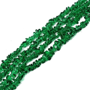 Macro detail of irregular green glass crystal beads for DIY jewelry and necklace crafting