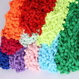 Close-up of colorful 10mm pom pom fringe trim ribbon for DIY sewing and home decor projects