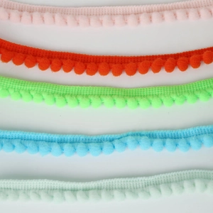 Close-up of 10mm colorful pom-pom fringe trim for DIY sewing and home decor projects
