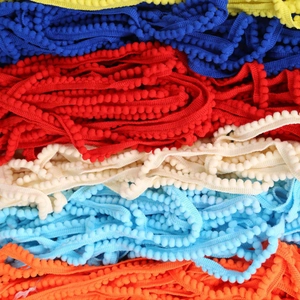 Colorful 10mm pompom trim ribbons in bright yellow, blue, and red for DIY sewing