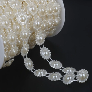 Elegant cream ABS faux pearl lace trim on a spool for DIY bridal dress accessories